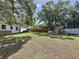 Large backyard showcasing a playset, wooden fence, and plenty of space for activities at 2114 Mount Vernon St, Orlando, FL 32803