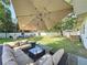 Spacious backyard featuring a patio area with comfortable seating, and a large grassy area at 2114 Mount Vernon St, Orlando, FL 32803