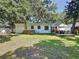 Green backyard featuring mature trees and the patio, offering a private outdoor area at 2114 Mount Vernon St, Orlando, FL 32803