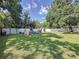 Large backyard featuring a playset, shed, and ample space for outdoor activities at 2114 Mount Vernon St, Orlando, FL 32803