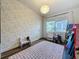 Charming bedroom with a pink rug, window, and decorative wallpaper at 2114 Mount Vernon St, Orlando, FL 32803