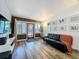 Stylish living room with hardwood floors, modern entertainment center, and views of the front yard at 2114 Mount Vernon St, Orlando, FL 32803
