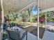 Inviting covered front porch featuring stylish outdoor seating and serene views of the lush, landscaped yard at 2114 Mount Vernon St, Orlando, FL 32803