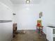 Utility room featuring a refrigerator, storage, and functional design at 2114 Mount Vernon St, Orlando, FL 32803