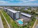 Aerial view showcases the condo, community pool, and covered parking at 3100 Ocean Shore Blvd # 4030, Ormond Beach, FL 32176