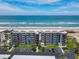 Aerial shot of beachfront condo with balconies, covered parking and lush landscaping at 3100 Ocean Shore Blvd # 4030, Ormond Beach, FL 32176