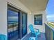 Balcony features sliding glass doors and blue Adirondack chairs at 3100 Ocean Shore Blvd # 4030, Ormond Beach, FL 32176