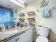 Well-lit bathroom featuring a modern vanity, stylish fixtures, and decorative nautical accents at 3100 Ocean Shore Blvd # 4030, Ormond Beach, FL 32176