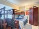 Well-appointed bedroom with a wooden bunk bed, and a storage cabinet at 3100 Ocean Shore Blvd # 4030, Ormond Beach, FL 32176