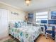Inviting bedroom featuring cheerful fish themed bedding, a dedicated workspace, and ample natural light at 3100 Ocean Shore Blvd # 4030, Ormond Beach, FL 32176