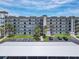 Beachfront condo featuring multiple balconies, covered parking, and mature palms at 3100 Ocean Shore Blvd # 4030, Ormond Beach, FL 32176