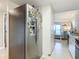 Kitchen with stainless steel fridge and view to the living area with balcony and ocean view at 3100 Ocean Shore Blvd # 4030, Ormond Beach, FL 32176