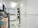 Complete kitchen with stainless steel appliances and white cabinetry plus in-unit washer and dryer at 3100 Ocean Shore Blvd # 4030, Ormond Beach, FL 32176