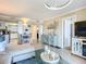 Comfortable open-concept living room with stylish furniture, adjacent kitchen, and a soothing color palette at 3100 Ocean Shore Blvd # 4030, Ormond Beach, FL 32176