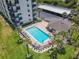 Aerial view of community pool with lounge chairs and lush landscaping at 3100 Ocean Shore Blvd # 4030, Ormond Beach, FL 32176