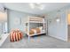 This bedroom includes bunkbeds, a modern light fixture and playful decor elements at 3156 Emerald Acres Ln, Sanford, FL 32771