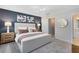 This bedroom features modern lighting, carpet, and a blue accent wall with decorative artwork above the bed at 3156 Emerald Acres Ln, Sanford, FL 32771