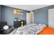 Bedroom with a cool tone accent wall, closet access, and gaming themed décor at 3156 Emerald Acres Ln, Sanford, FL 32771