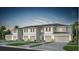 Charming townhome features a neutral color palette, attached garages, and lush landscaping at 3156 Emerald Acres Ln, Sanford, FL 32771