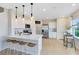 Bright, modern kitchen features white cabinetry, a center island with seating, and stainless steel appliances at 3156 Emerald Acres Ln, Sanford, FL 32771