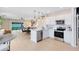 Open concept kitchen features modern appliances, pendant lighting, and a view to the dining area at 3156 Emerald Acres Ln, Sanford, FL 32771