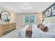 Bright main bedroom features a dresser, neutral color palette, and ensuite bathroom at 3156 Emerald Acres Ln, Sanford, FL 32771