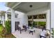 This covered patio has outdoor seating and a sliding glass door leading into the house at 3156 Emerald Acres Ln, Sanford, FL 32771