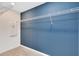 Inside this walk-in closet are wire racks for storage space and a large blue accent wall at 3156 Emerald Acres Ln, Sanford, FL 32771