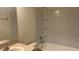 Clean bathroom featuring a tub and shower combination with tiled walls at 3166 Riachuelo Ln, Kissimmee, FL 34744