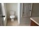 Small bathroom features a toilet, cabinet, and a window at 3166 Riachuelo Ln, Kissimmee, FL 34744