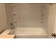 Bright bathroom featuring a bathtub with white subway tile and built in shelving at 3166 Riachuelo Ln, Kissimmee, FL 34744