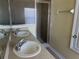 Bathroom showcasing double sinks and glass-enclosed shower at 3166 Riachuelo Ln, Kissimmee, FL 34744
