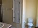Full bathroom featuring a toilet, towel rack and storage at 3166 Riachuelo Ln, Kissimmee, FL 34744