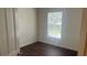 Bright bedroom features a window and dark wood-look floors at 3166 Riachuelo Ln, Kissimmee, FL 34744