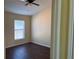 Bedroom features hardwood floors, a window, and a ceiling fan at 3166 Riachuelo Ln, Kissimmee, FL 34744
