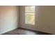A bright bedroom features a window and laminate flooring with a view of lush outdoor plants at 3166 Riachuelo Ln, Kissimmee, FL 34744