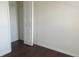 A bright bedroom has dark wood-look floors and a closet with a white door at 3166 Riachuelo Ln, Kissimmee, FL 34744