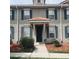 Charming two-story townhome featuring neutral paint, blue shutters, and a decorative tile entryway roof at 3166 Riachuelo Ln, Kissimmee, FL 34744