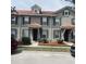 Stylish townhome featuring a tile roof, neutral paint, blue shutters, and well-maintained landscaping at 3166 Riachuelo Ln, Kissimmee, FL 34744