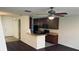 Open-concept kitchen with dark cabinetry, modern appliances, and a breakfast bar for casual dining at 3166 Riachuelo Ln, Kissimmee, FL 34744