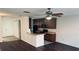 Open-concept kitchen with dark cabinetry, modern appliances, and a breakfast bar for casual dining at 3166 Riachuelo Ln, Kissimmee, FL 34744
