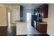 Well-lit kitchen with dark cabinetry, modern appliances, and tiled flooring for a clean aesthetic at 3166 Riachuelo Ln, Kissimmee, FL 34744