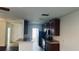 Well-lit kitchen with dark cabinetry, modern appliances, and tiled flooring for a clean aesthetic at 3166 Riachuelo Ln, Kissimmee, FL 34744
