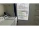 Laundry room featuring a washer, dryer, and storage shelving near a bright window at 3166 Riachuelo Ln, Kissimmee, FL 34744