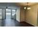 Bright living room features sleek flooring, a modern ceiling fan, and sliding doors for natural light at 3166 Riachuelo Ln, Kissimmee, FL 34744
