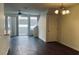 Bright living room features sleek flooring, a modern ceiling fan, and sliding doors for natural light at 3166 Riachuelo Ln, Kissimmee, FL 34744