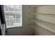 A walk-in pantry featuring wire shelving and a window at 3166 Riachuelo Ln, Kissimmee, FL 34744