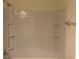 Shower stall with white tiled surround, built-in shelves, and shower head at 3166 Riachuelo Ln, Kissimmee, FL 34744