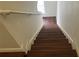 View of wooden staircase leading upstairs with white walls and a handrail at 3166 Riachuelo Ln, Kissimmee, FL 34744