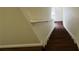 View of hardwood staircase ascending in a bright home, featuring a sturdy handrail at 3166 Riachuelo Ln, Kissimmee, FL 34744